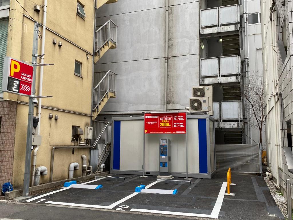 a parking lot in front of a building at Sakura Hotel Ikebukuro in Tokyo