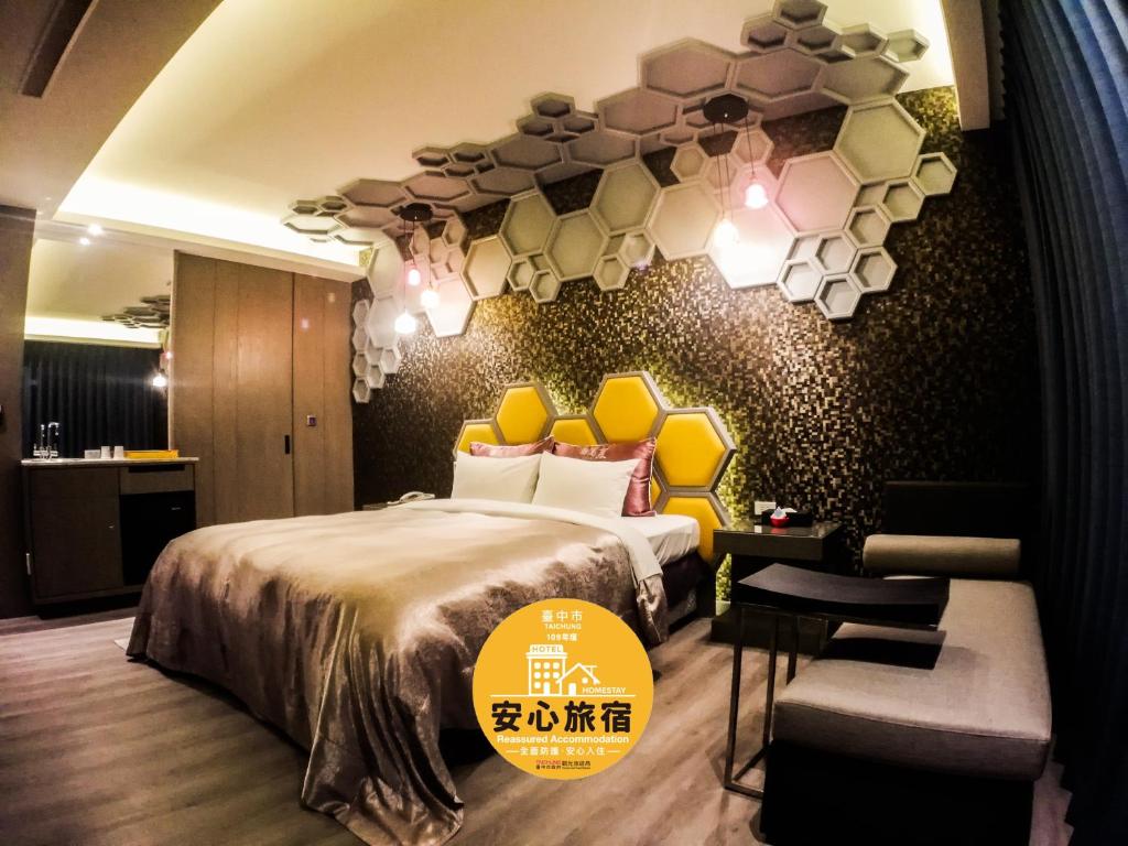 a hotel room with a bed with a yellow headboard at Song Xia Motel in Dali