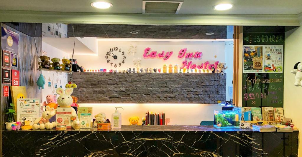 a shop counter with a sign that says boy bear world at EasyInn Hotel & Hostel in Tainan