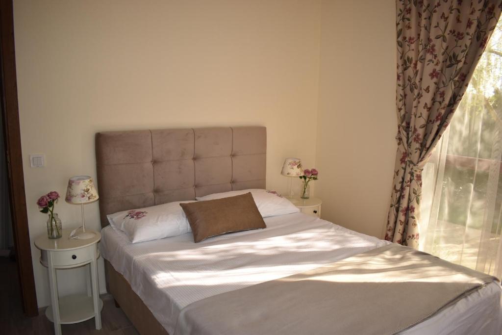a bedroom with a large bed with a window at Cascadas Ravda - Gorgeous 2 bedrooms family apartment in Ravda