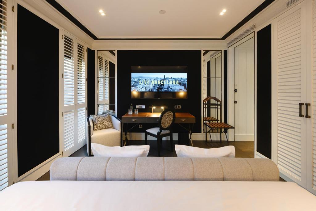 a bedroom with a bed and a living room at Seventy Barcelona in Barcelona