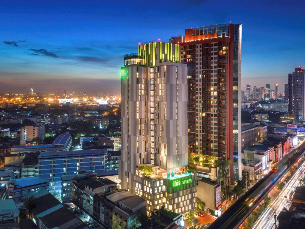 a rendering of a tall building in a city at night at ibis Styles Bangkok Sukhumvit Phra Khanong in Bangkok