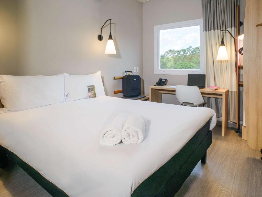 Cama ou camas em um quarto em ibis Itatiba