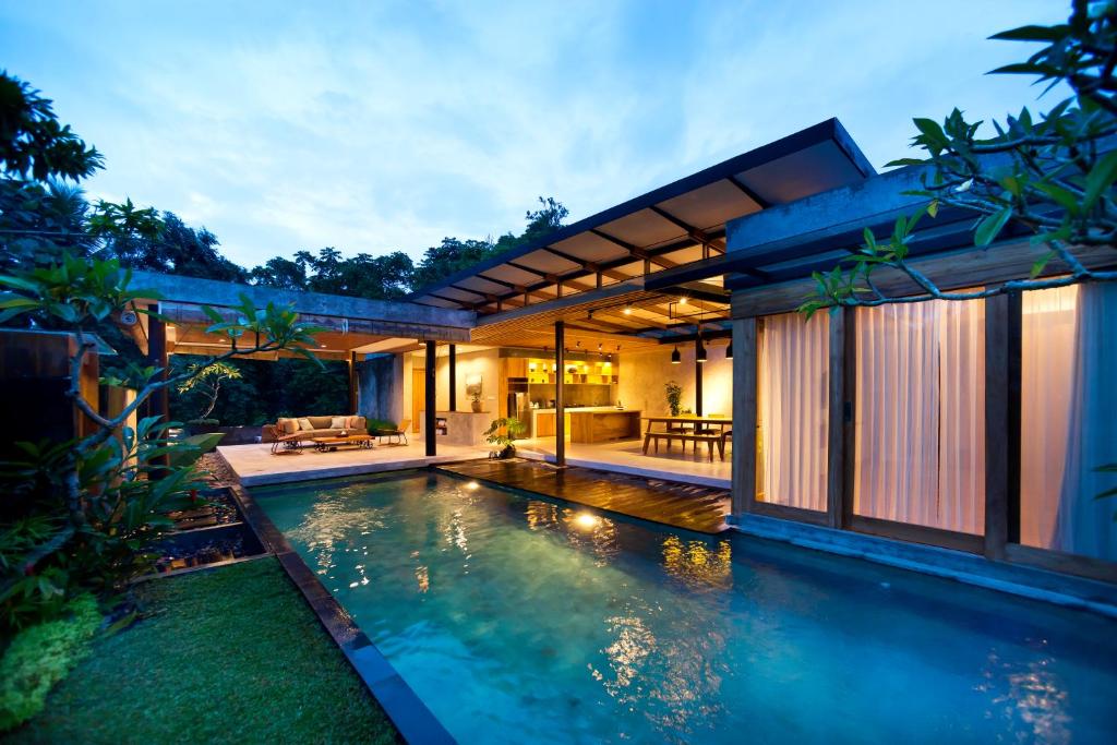 a swimming pool in the backyard of a house at Sativa Villas Ubud with Private Pool in Ubud