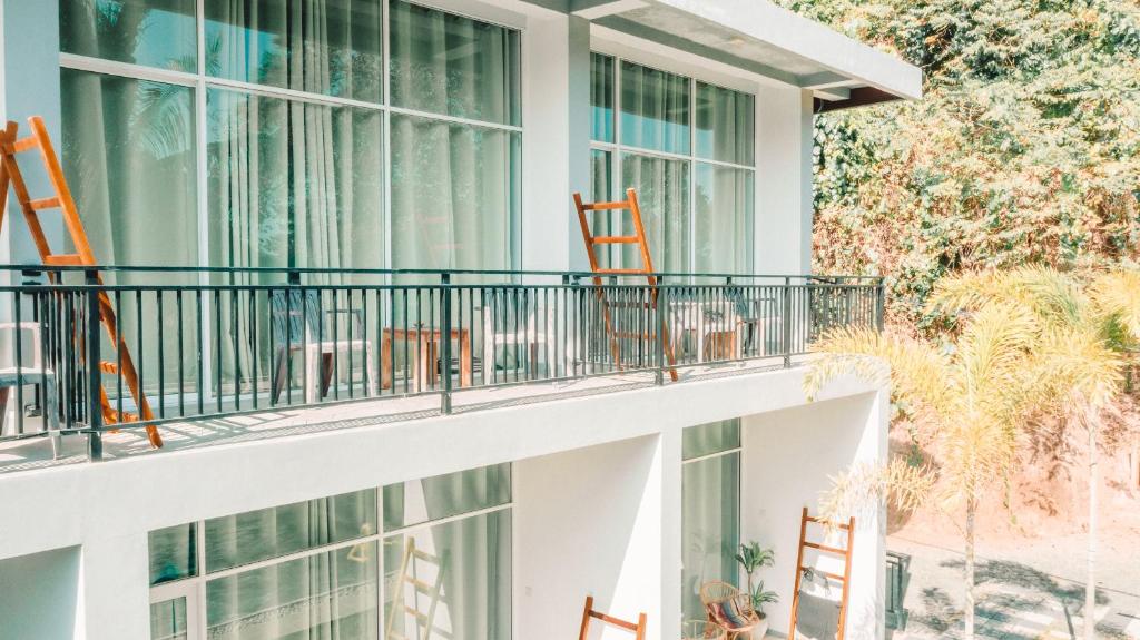 a balcony of a building with orange chairs at Green Hill Mirissa in Mirissa