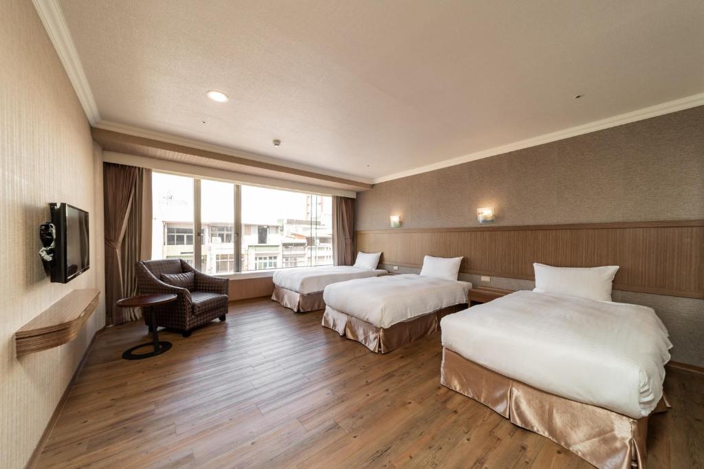 A bed or beds in a room at Fish Hotel-Pingtung