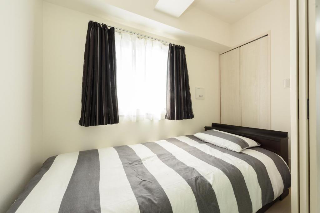 Ένα ή περισσότερα κρεβάτια σε δωμάτιο στο Cocostay KO Residence Sennichimae#603ココステイ ケーオーレジデンス センニチマエ#603
