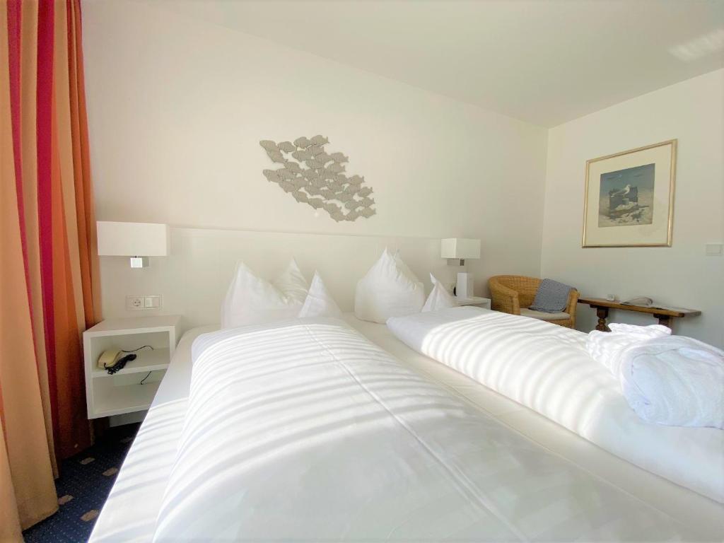 Postel nebo postele na pokoji v ubytování Hotel Wünschmann