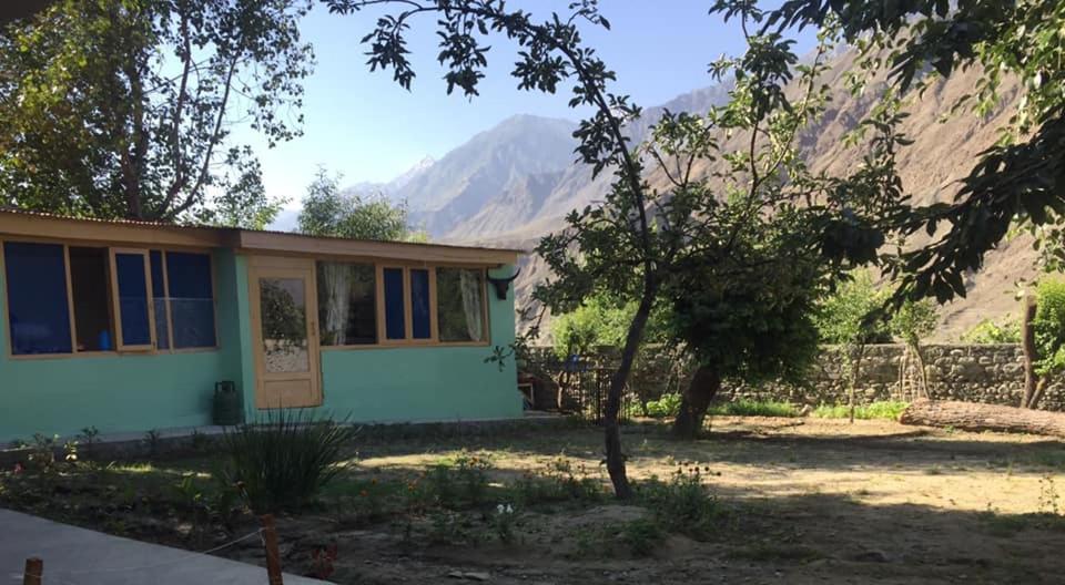 a house with a mountain in the background at River Breeze Guest House 