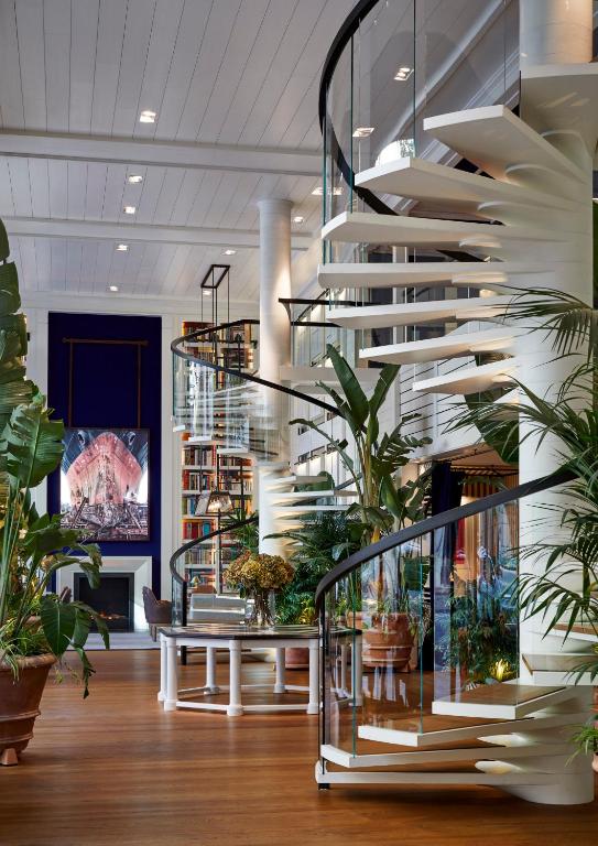 a spiral staircase in a room with plants at Seventy Barcelona in Barcelona