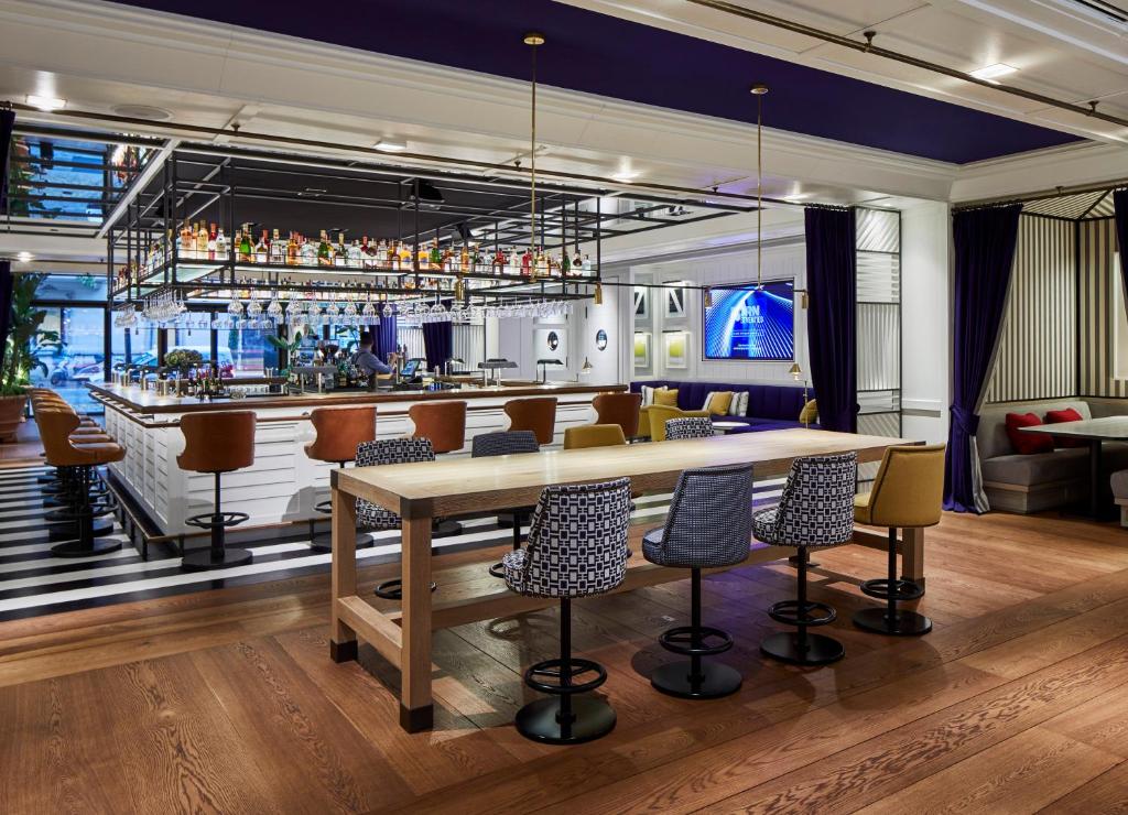 a bar with a wooden table and chairs at Seventy Barcelona in Barcelona