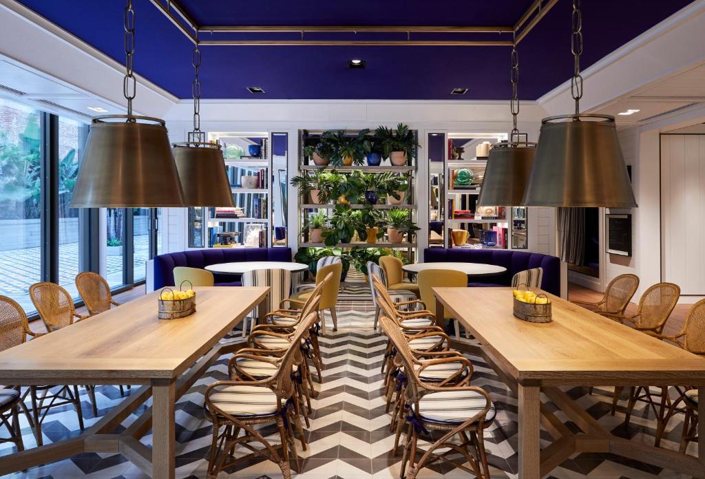 a restaurant with tables and chairs and large windows at Seventy Barcelona in Barcelona
