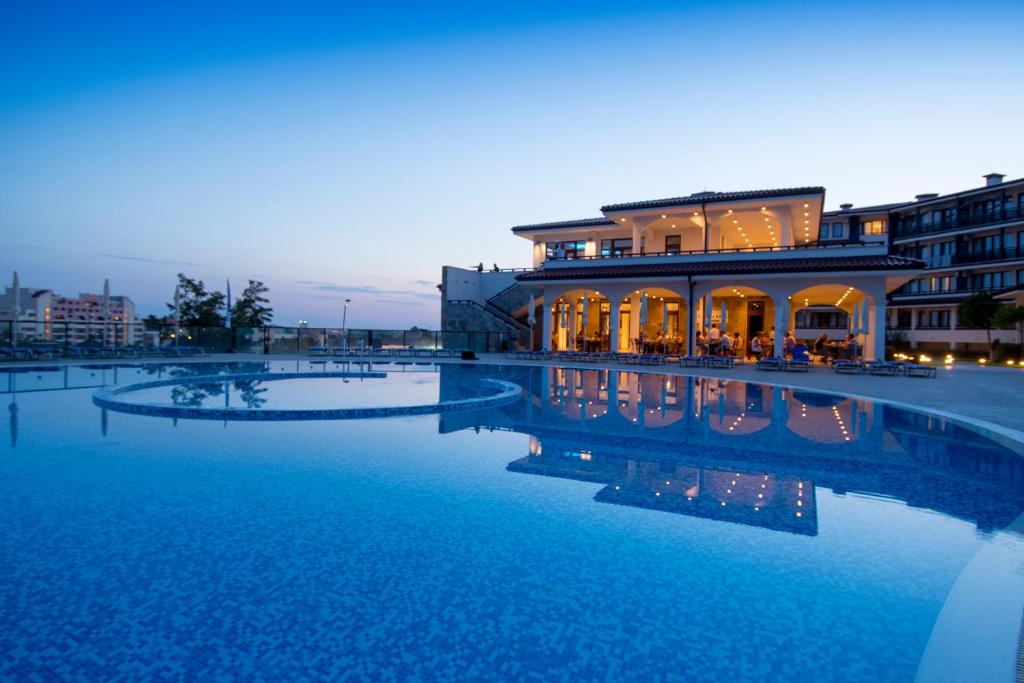 a large pool of water in front of a building at Nevis Resort & Aqua Park - All Inclusive in Sunny Beach