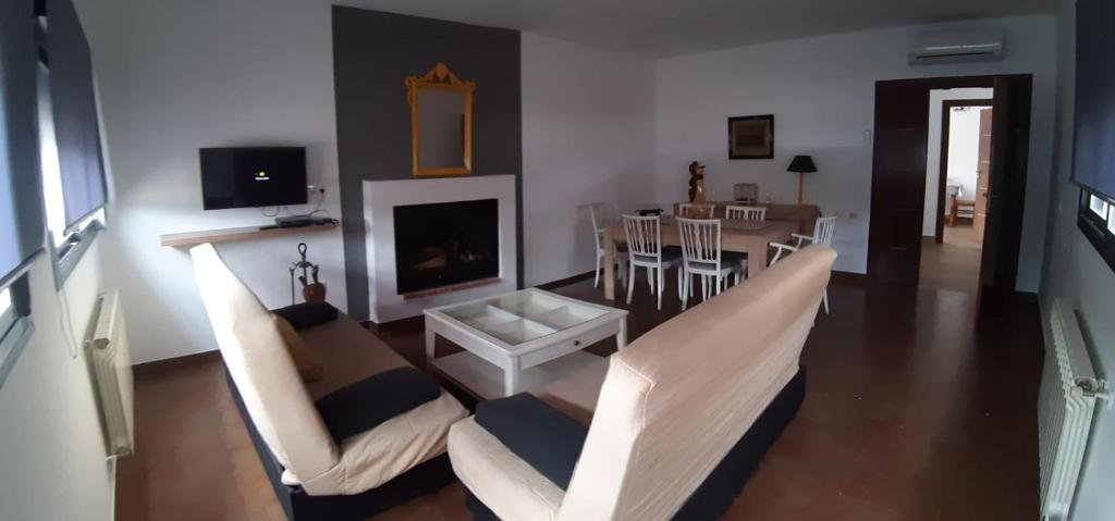 a living room with two chairs and a fireplace at Las Eras 2 in Herencia