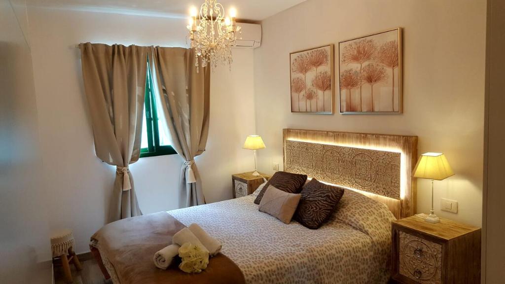 a bedroom with a bed with a stuffed animal on it at Enjoy days of dreams in paradise, 2 BR with POOL in Maspalomas