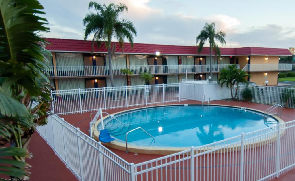 a large pool in front of a hotel at Express Inn & Suites - 5 Miles from St Petersburg Clearwater Airport in Clearwater