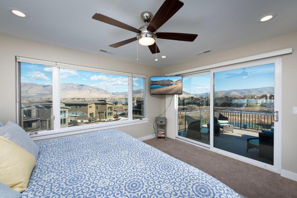 a bedroom with a bed and a ceiling fan at Gorgeous Decor with Private Hot Tub EW23 in Huntsville