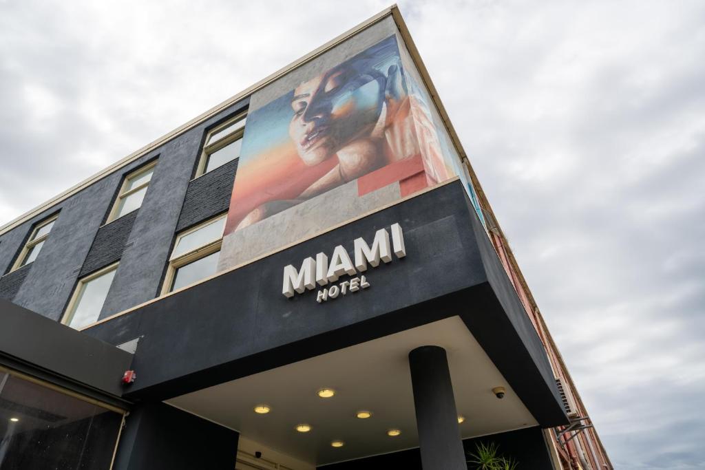a large billboard on the side of a building at Miami Hotel Melbourne in Melbourne