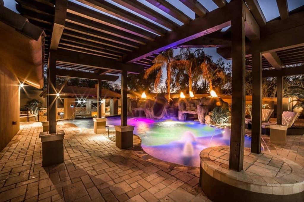 a swimming pool with a fountain at night at Estate Resort Style Oasis 6BDRM, 5.5 Bath Heated Pool with Misters in Scottsdale