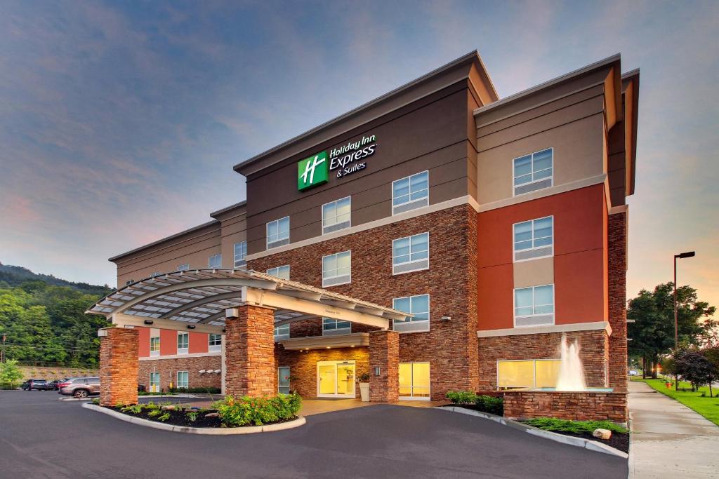a hotel with a sign on the front of a building at Holiday Inn Express & Suites - Ithaca, an IHG Hotel in Ithaca