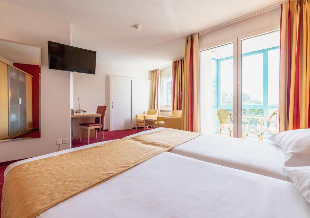 Voodi või voodid majutusasutuse Grand Hotel et Centre Thermal d'Yverdon-les-Bains toas