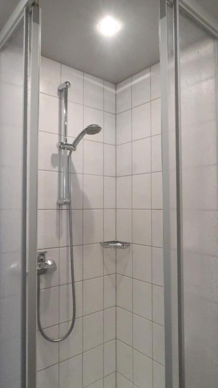 a shower with a glass door in a bathroom at Hotel Garni Löwen in Silz