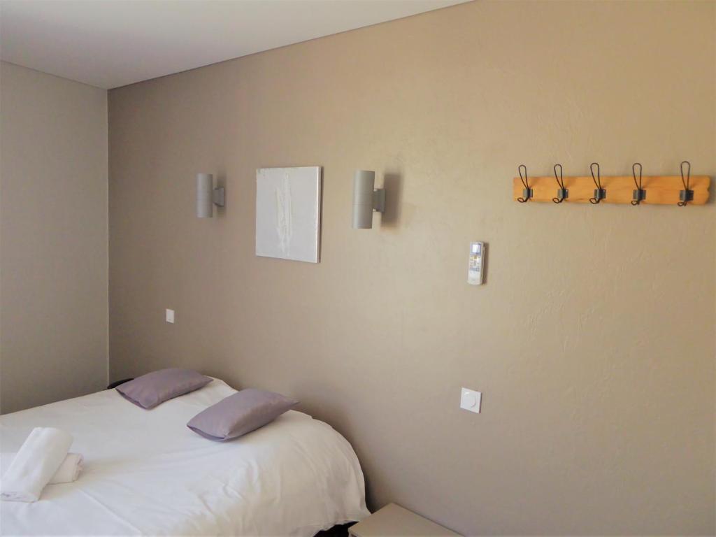 een slaapkamer met een bed met 2 kussens erop bij Auberge de la Paillère in Lavours