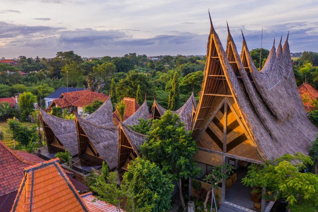 an aerial view of a church with its roofs at Premadhan Cottage Canggu in Canggu