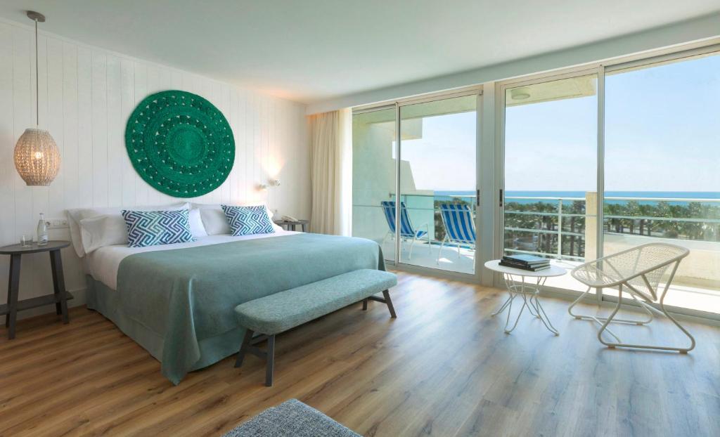 a bedroom with a bed and a view of the ocean at Blaumar Hotel in Salou