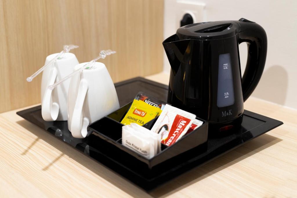 a black coffee maker sitting on top of a counter at Cordia Hotel Yogyakarta - Hotel Dalam Bandara in Glagah