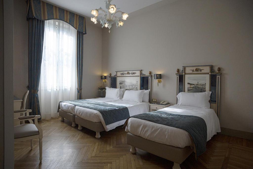 Postel nebo postele na pokoji v ubytování Hotel Donatello