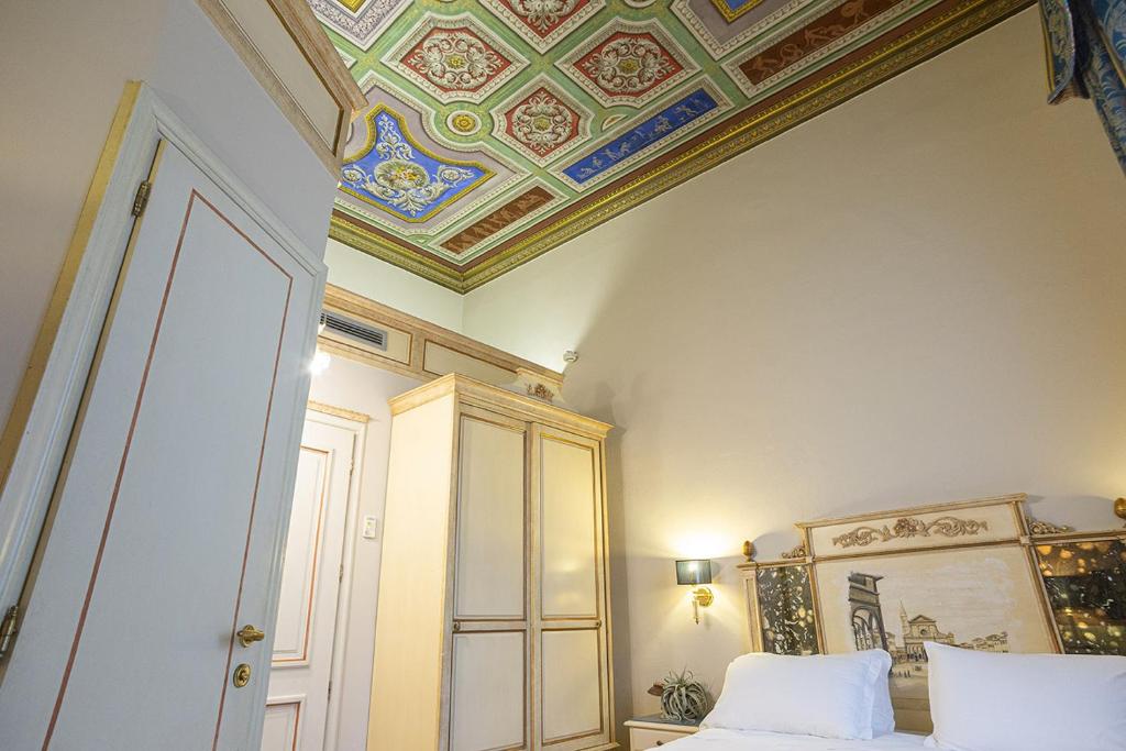 Postel nebo postele na pokoji v ubytování Hotel Donatello