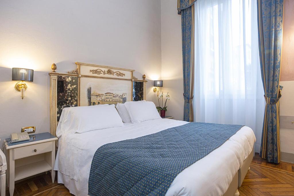 Postel nebo postele na pokoji v ubytování Hotel Donatello