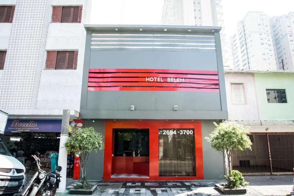 a store front with a red door in a city at Belém Hotel in São Paulo