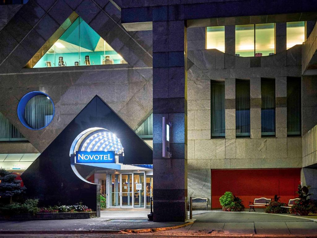 a hotel with a sign on the front of a building at Novotel Toronto North York in Toronto