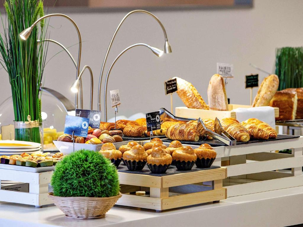 a buffet of bread and pastries on a table at Mercure Paris Vaugirard Porte De Versailles in Paris