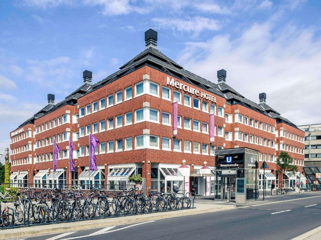 a large brick building with bikes parked in front of it at Mercure Hotel Severinshof Köln City in Cologne