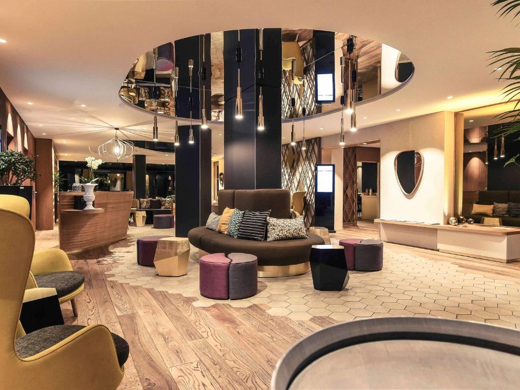 a lobby with a couch and chairs in a store at Mercure Dijon Centre Clemenceau in Dijon