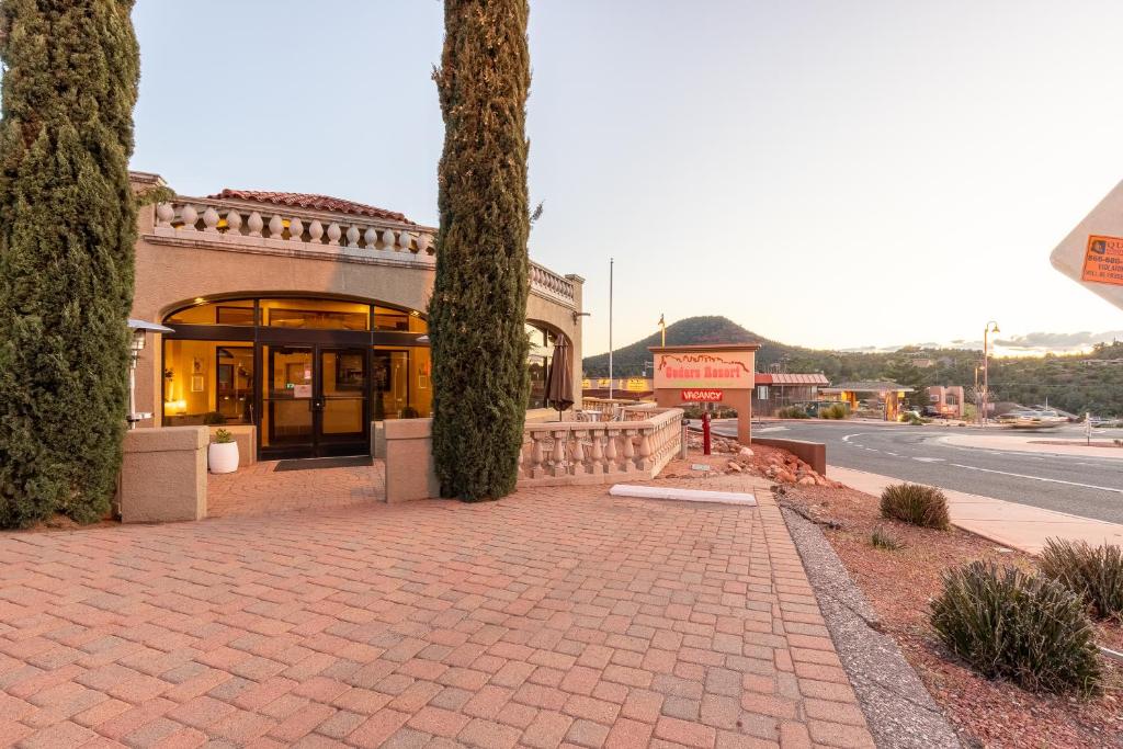 a building with two trees next to a street at Cedars Resort in Sedona