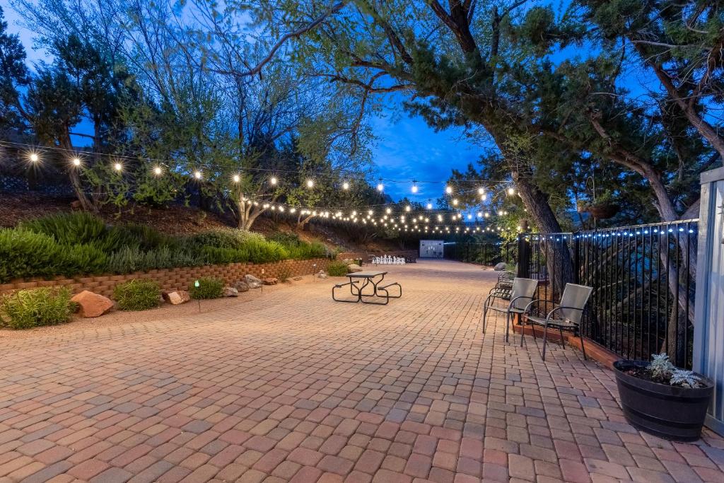 a patio with benches and lights at night at Cedars Resort in Sedona