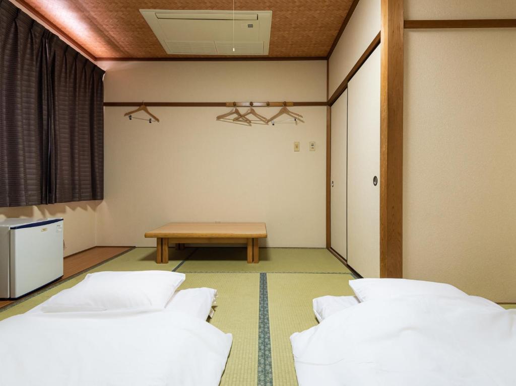 Postel nebo postele na pokoji v ubytování Tabist Hotel Kurama Hikone