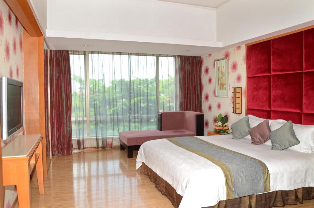 Postel nebo postele na pokoji v ubytování Dongguan Well Garden Hotel