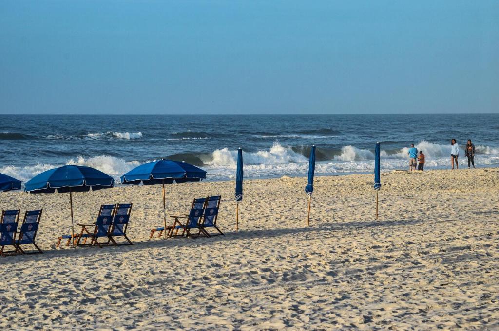 a group of chairs and umbrellas on a beach at Super Cute With Deeded Beach Access (#26) - Sleeps 5 in Gulf Shores