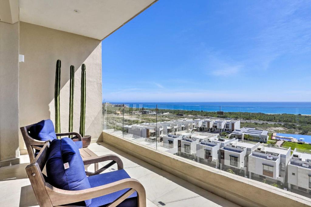 a room with a view of the ocean from a balcony at Luxe Cabo Condo w/ Ocean Views + Amenities! in Cabo San Lucas
