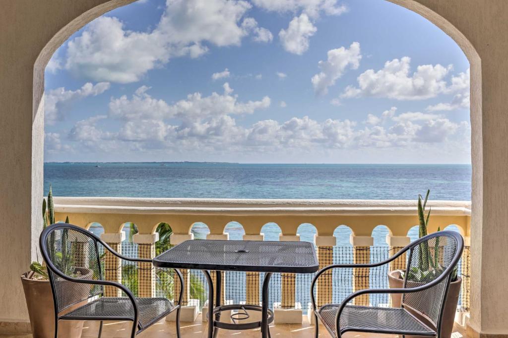a table and chairs on a balcony with a view of the ocean at Private Balcony with Views Oceanfront Cancun Condo! in Cancún