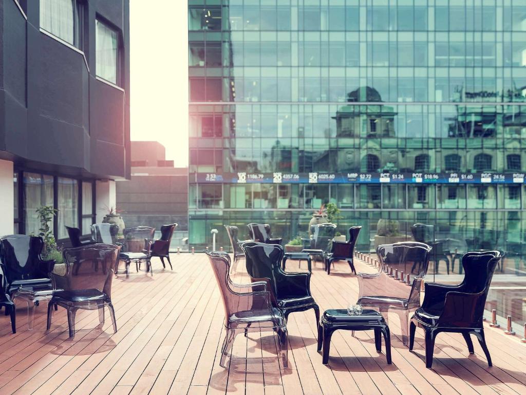 a row of chairs and tables in a building at Mövenpick Hotel Auckland in Auckland
