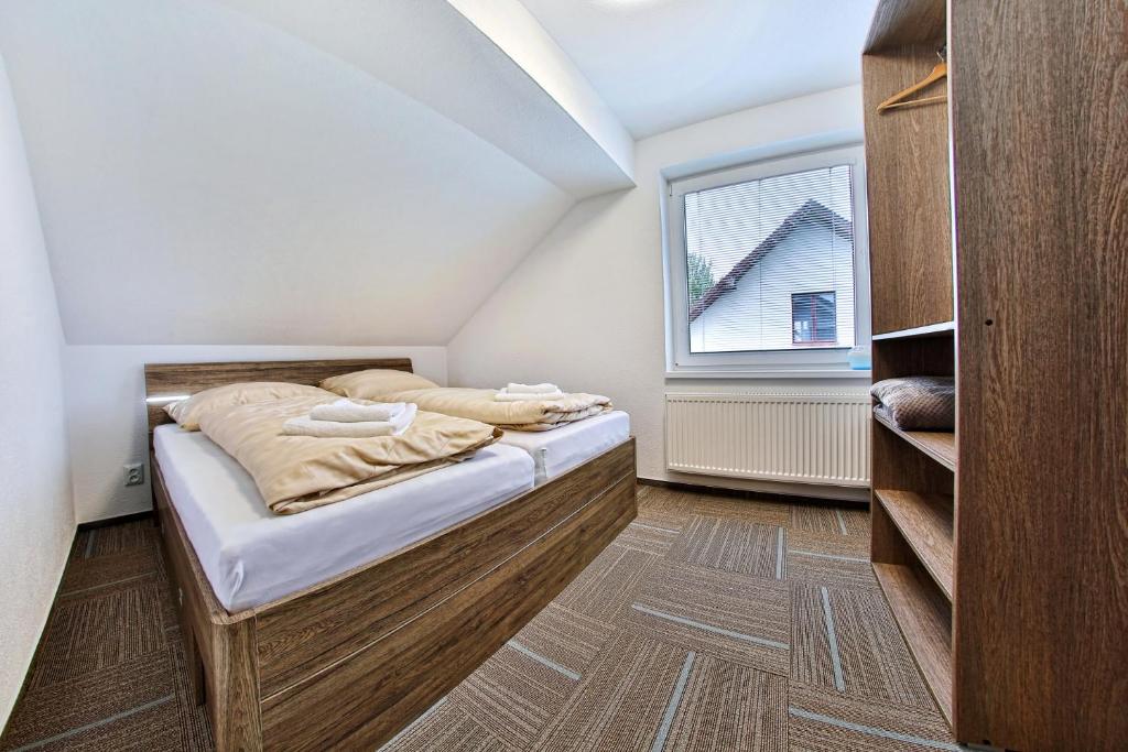 Postel nebo postele na pokoji v ubytování Apartmany za Rohom