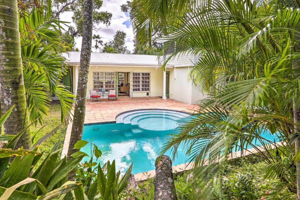 a pool in front of a house with palm trees at Bright St Thomas Getaway with Pool, 3Mi to Magens Bay in Mafolie