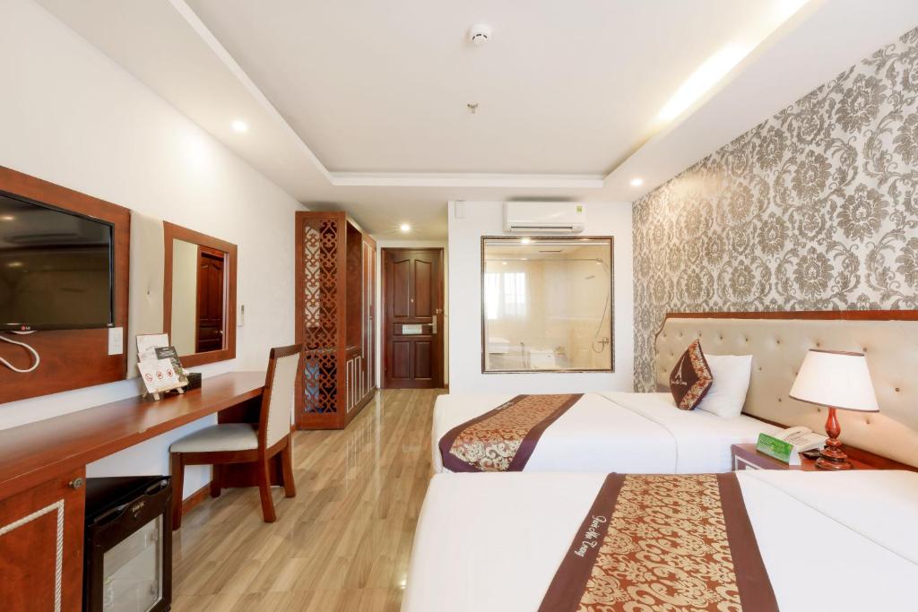 Giường trong phòng chung tại Paris Luxury Hotel & Apartment Nha Trang