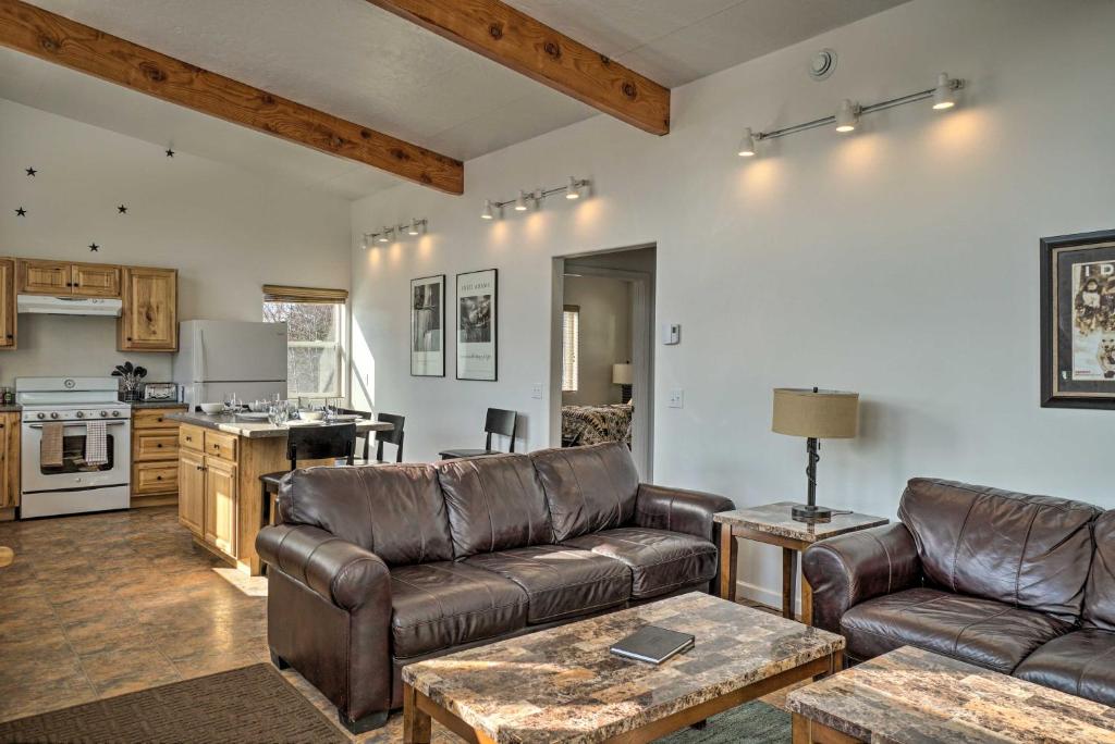 a living room with a couch and a table at Pet-Friendly Duplex with Northern Lights Aurora View in Homer